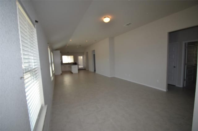 interior space featuring light floors and lofted ceiling