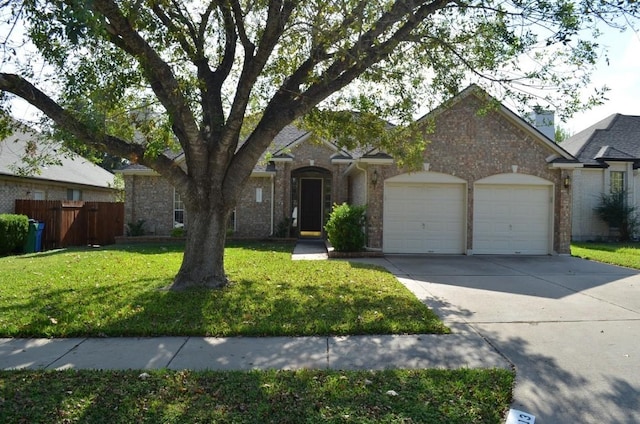 ranch-style house featuring a front lawn and a garage