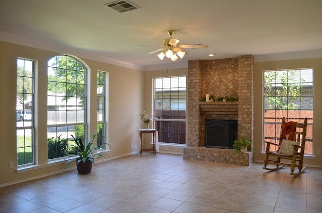 living room with a fireplace, light tile patterned floors, ceiling fan, and crown molding