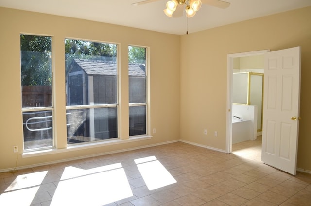 tiled empty room with ceiling fan