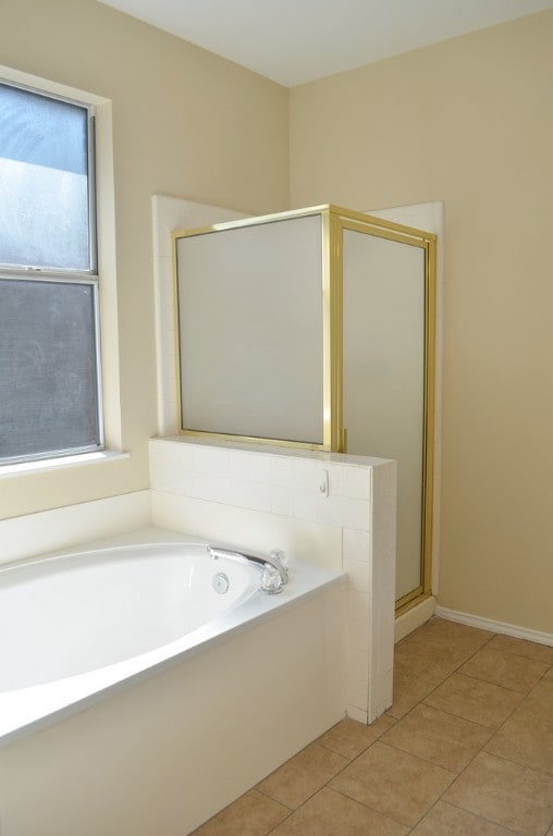 bathroom with tile patterned floors and independent shower and bath