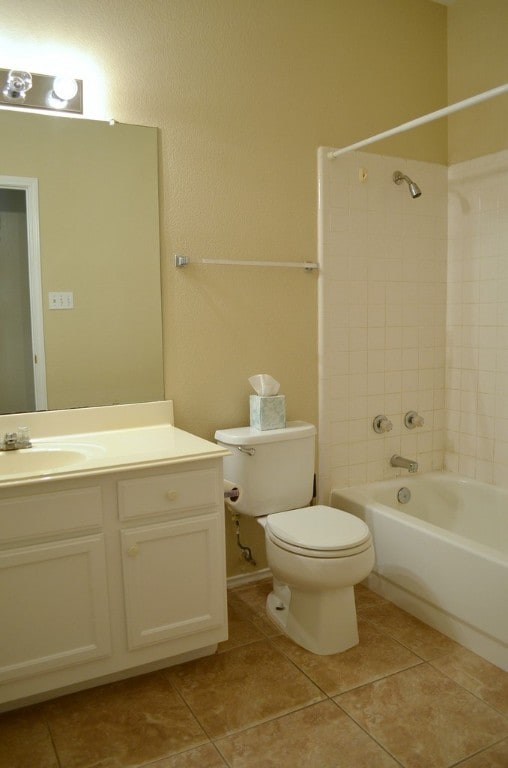 full bathroom featuring toilet, vanity, tile patterned floors, and tiled shower / bath