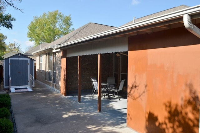 view of home's exterior featuring a patio and a storage shed