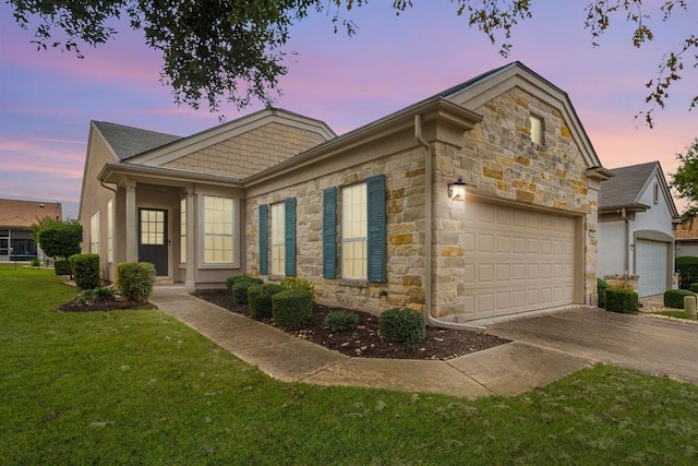 view of front of property featuring a garage and a lawn