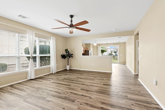 empty room with light hardwood / wood-style flooring and ceiling fan