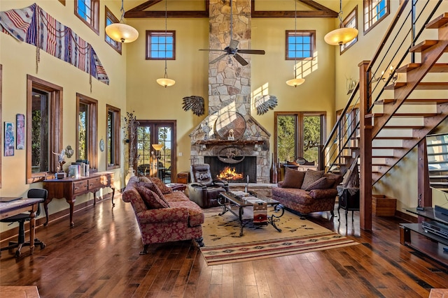 living room with a high ceiling, wood-type flooring, and beam ceiling