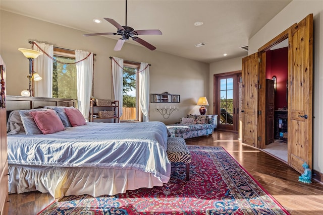 bedroom with hardwood / wood-style flooring, ceiling fan, and multiple windows