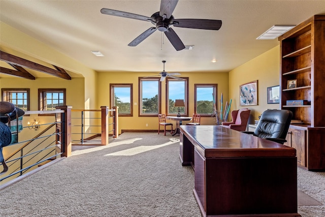 office area with plenty of natural light, beam ceiling, and carpet