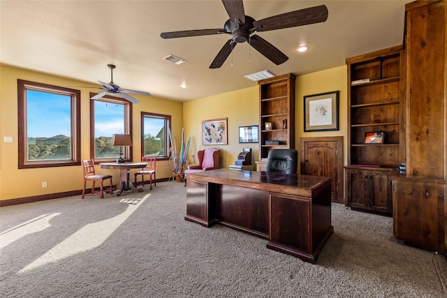 home office featuring ceiling fan and dark colored carpet