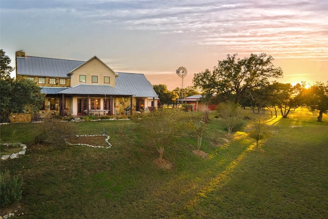 exterior space featuring a lawn and a porch