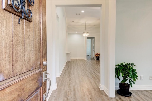 corridor with light wood-type flooring