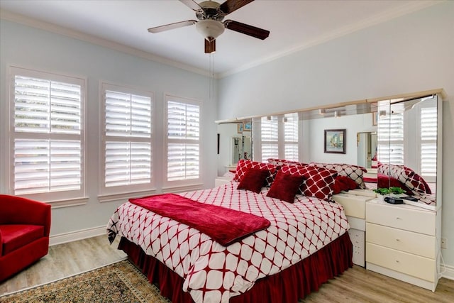 bedroom with ceiling fan, light hardwood / wood-style floors, and ornamental molding