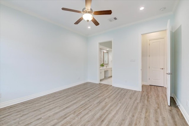 spare room featuring ceiling fan, light wood-type flooring, and crown molding