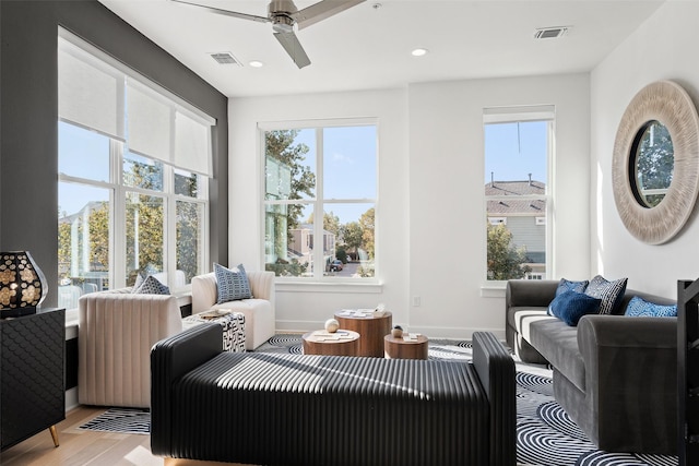 interior space featuring ceiling fan, a healthy amount of sunlight, and light wood-type flooring