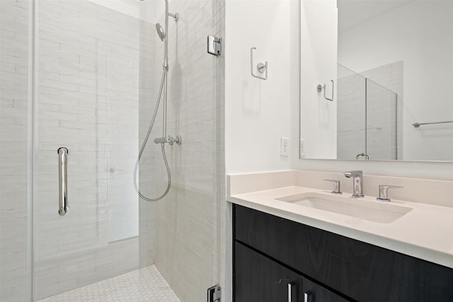 bathroom with vanity and a shower with shower door