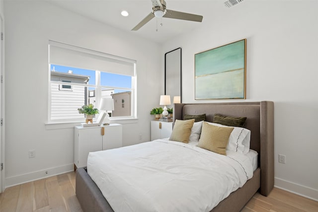 bedroom with light hardwood / wood-style flooring and ceiling fan