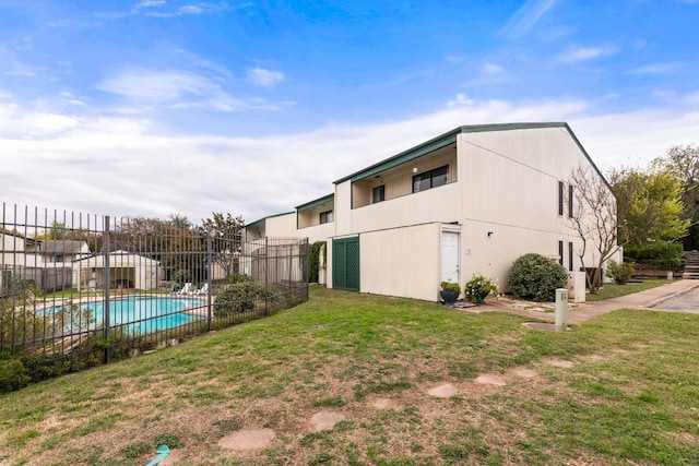 exterior space with a fenced in pool