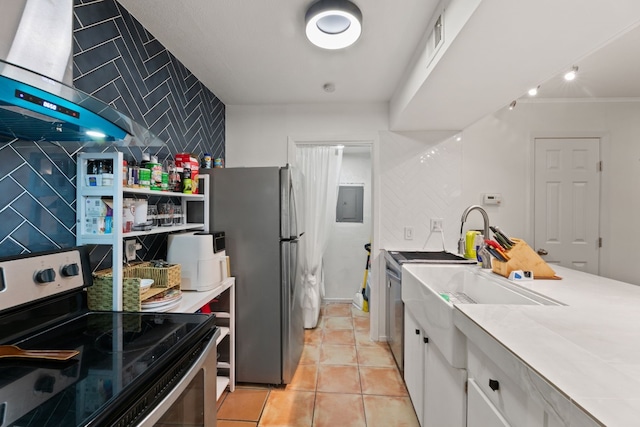 kitchen with white cabinets, light tile patterned floors, tile walls, black electric range, and stainless steel refrigerator