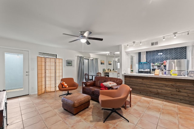 tiled living room featuring ceiling fan