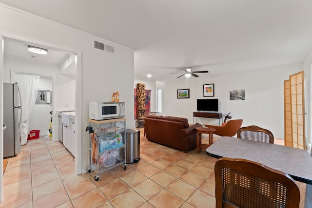 tiled living room featuring ceiling fan