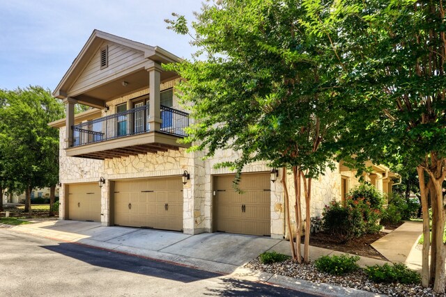 view of front of property with a balcony and a garage