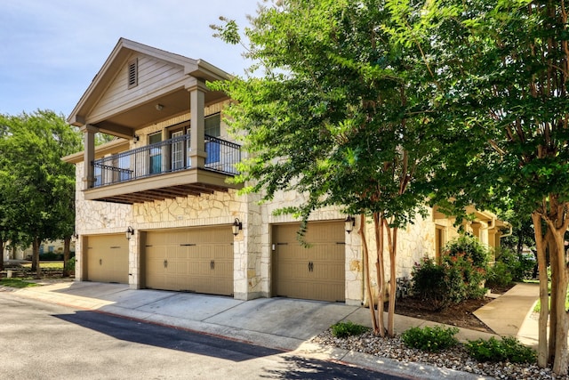 view of front of house featuring a balcony and a garage