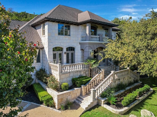 view of front of home featuring covered porch and a balcony