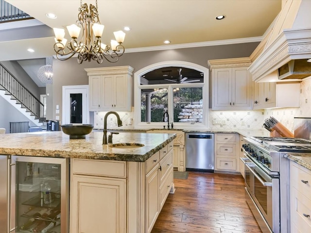 3001 Pescadero Cv, Austin, TX 78746 - kitchen featuring a notable chandelier, cream cabinets, wine cooler, stainless steel appliances, and a sink