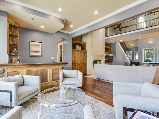 living room featuring crown molding and hardwood / wood-style flooring