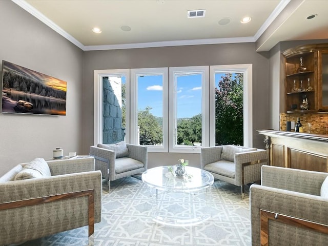 living area featuring ornamental molding