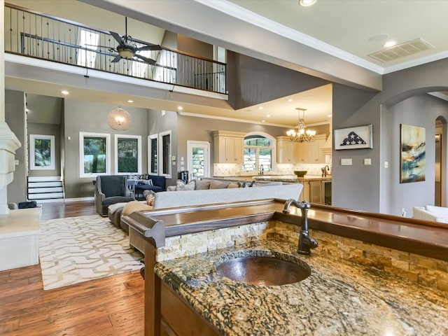 3001 Pescadero Cv, Austin, TX 78746 - interior space featuring visible vents, arched walkways, a sink, ornamental molding, and hardwood / wood-style flooring