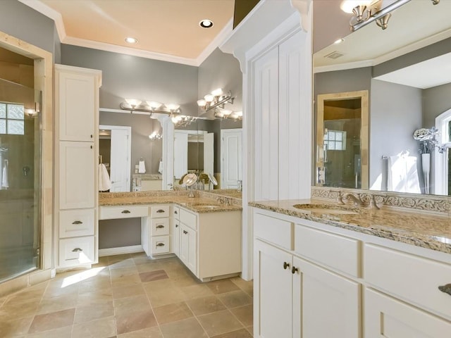 bathroom with vanity, a shower with door, and crown molding