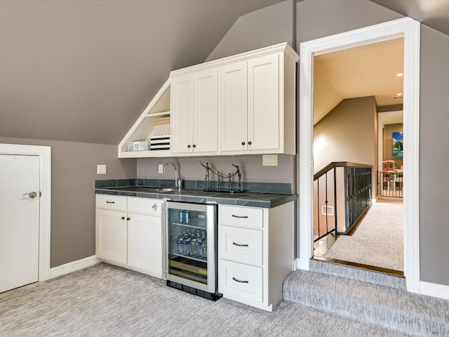 3001 Pescadero Cv, Austin, TX 78746 - bar featuring wet bar, vaulted ceiling, light carpet, a sink, and beverage cooler