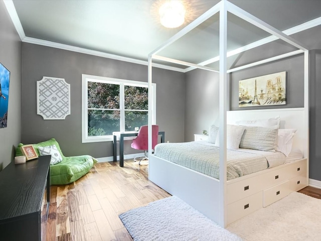 bedroom with wood-type flooring and ornamental molding