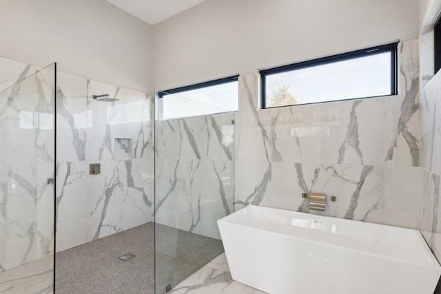 bathroom with tile walls and plus walk in shower