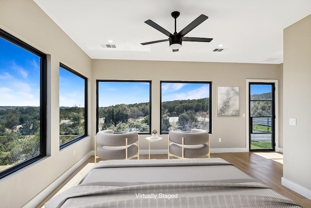 unfurnished sunroom featuring ceiling fan