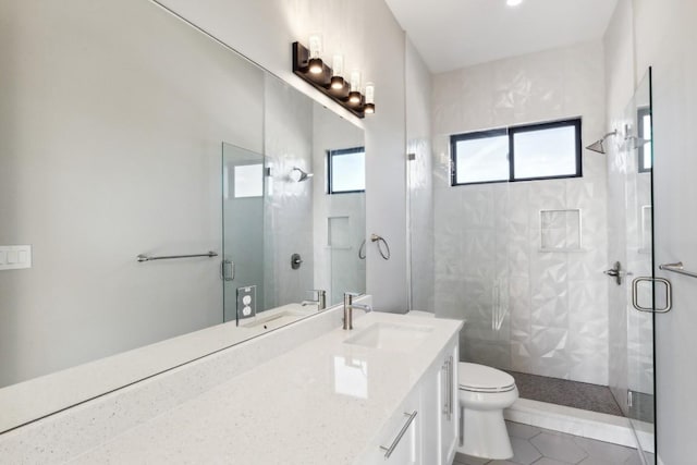 bathroom with tile patterned flooring, vanity, toilet, and a shower with shower door