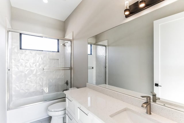 full bathroom with vanity, toilet, and enclosed tub / shower combo