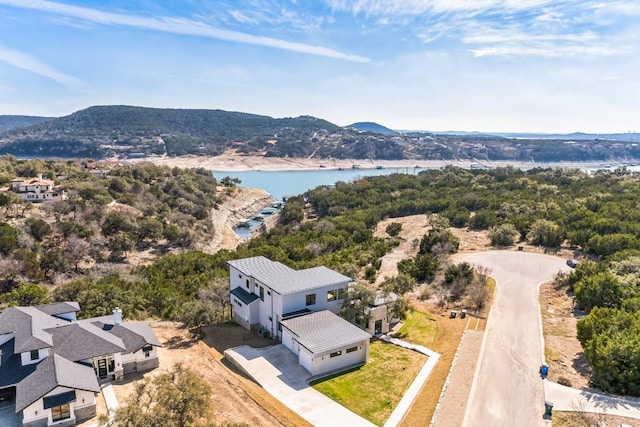 birds eye view of property with a water and mountain view