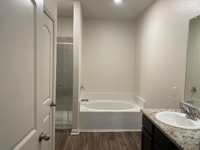 bathroom with vanity, shower with separate bathtub, and hardwood / wood-style flooring