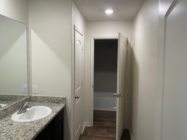 bathroom with hardwood / wood-style flooring and vanity