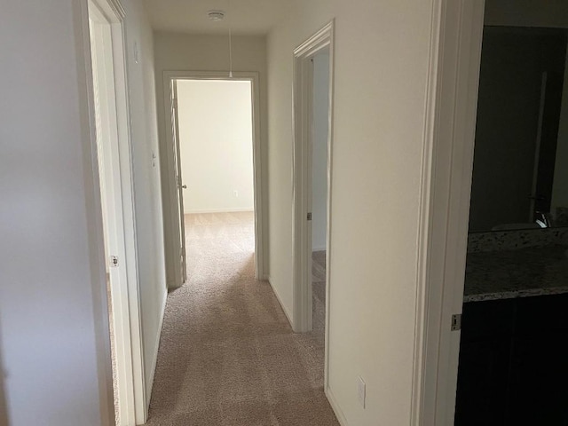 hallway featuring light carpet