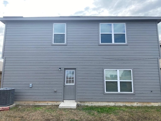 back of house featuring cooling unit