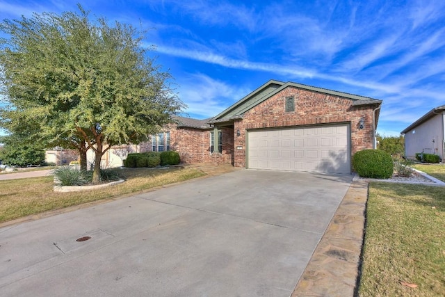 view of front of property featuring a front yard and a garage