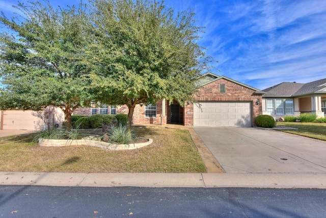 view of front of property featuring a garage and a front lawn