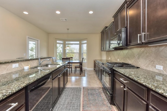 kitchen with sink, tasteful backsplash, light stone counters, dark brown cabinets, and black appliances