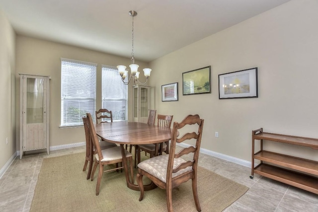 tiled dining area with an inviting chandelier