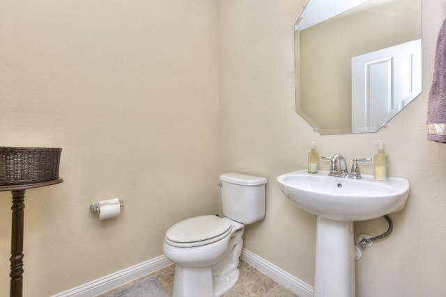 bathroom with sink, tile patterned flooring, and toilet