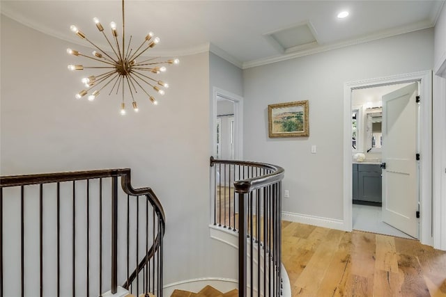 hall featuring an inviting chandelier, an upstairs landing, crown molding, baseboards, and light wood-style flooring