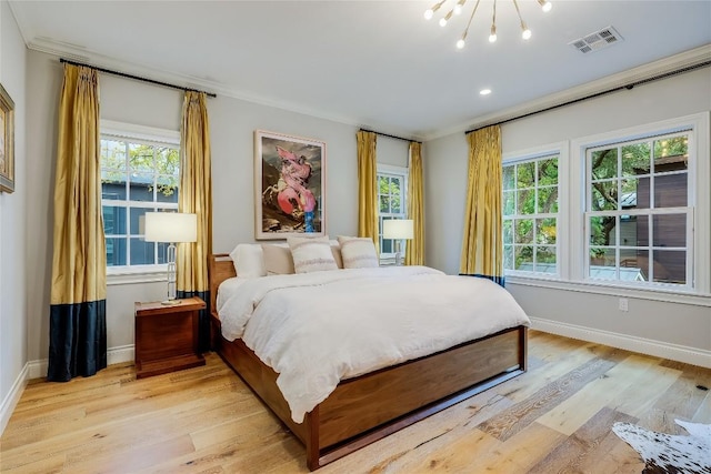 bedroom with a chandelier, light wood-type flooring, multiple windows, and ornamental molding